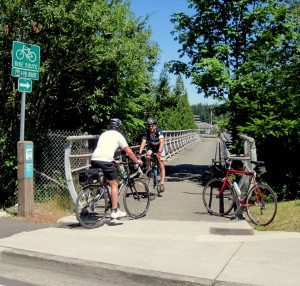 Bicyclists come and go over I-90 ped bridge in Bellevue