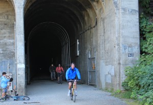 Bicyclists emerge from the tunnel
