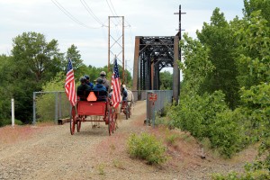 Horse drawn wagon crossing rail-trail bridge near Ellensburg